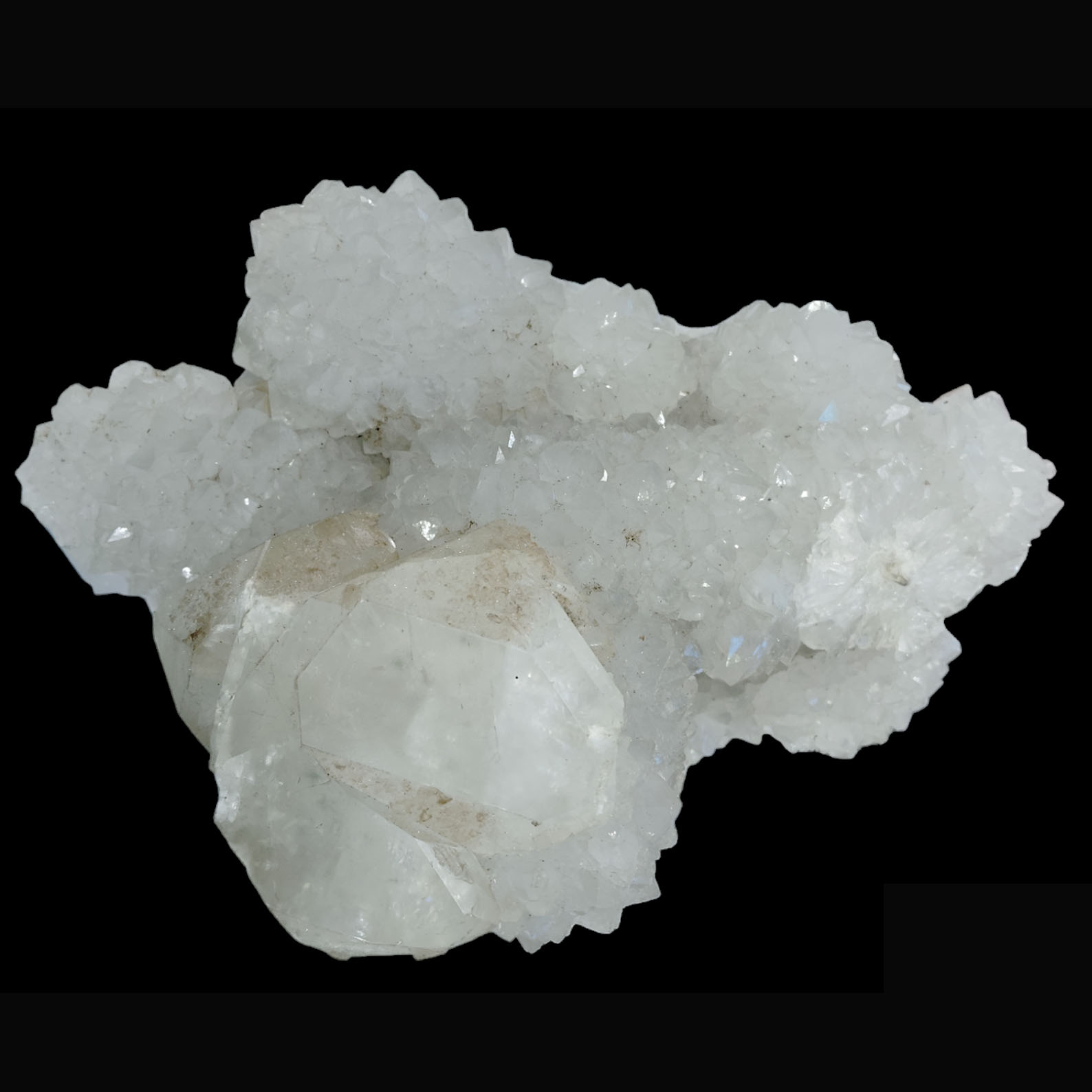 Muktidaya Vinayaka

(“Muktidaya”  “Vinayaka” being another name for Lord Ganesha, the remover of obstacles in Hinduism.)

Physical Description:

Primary Mineral Type: Likely Apophyllite with associated Stilbite
(Based on the large, lustrous crystal faces and the overall cluster form.)

Color:

Predominantly translucent white to milky clear

Crystal Formation:

The specimen displays a prominent hexagonal, prismatic crystal (bottom right),  Apophyllite, showing excellent termination and glassy luster.

Surrounding this are numerous smaller druzy crystals, which create a shimmering effect across the surface.

The larger crystal has natural geometric symmetry, with well-defined cleavage planes, almost resembling a sacred geometric formation, enhancing its spiritual symbolism.

Texture :

The surface shows a vitreous to pearly luster, particularly on the larger crystal faces.

Fine crystalline structure on the cluster adds contrast and depth.


Apophyllite is known for:

Enhancing intuition and connection with spiritual realms.

Promoting inner peace and clarity.

Acting as a conduit for Reiki and energy healing.

Stilbite, often found with Apophyllite, aids in:

Heart chakra activation.

Gentle emotional release.

Dream recall and spiritual journeying.

Ideal Use:

Meditation Focus Piece: Use as a centerpiece during spiritual practices.

Muktidaya Vinayaka is more than a mineral specimen — it is a crystalline embodiment of divine liberation, wisdom, and protection. With its radiant white clarity, sacred geometry, and grounding inclusions, it offers both aesthetic beauty and spiritual power, making it a truly remarkable and meaningful piece.