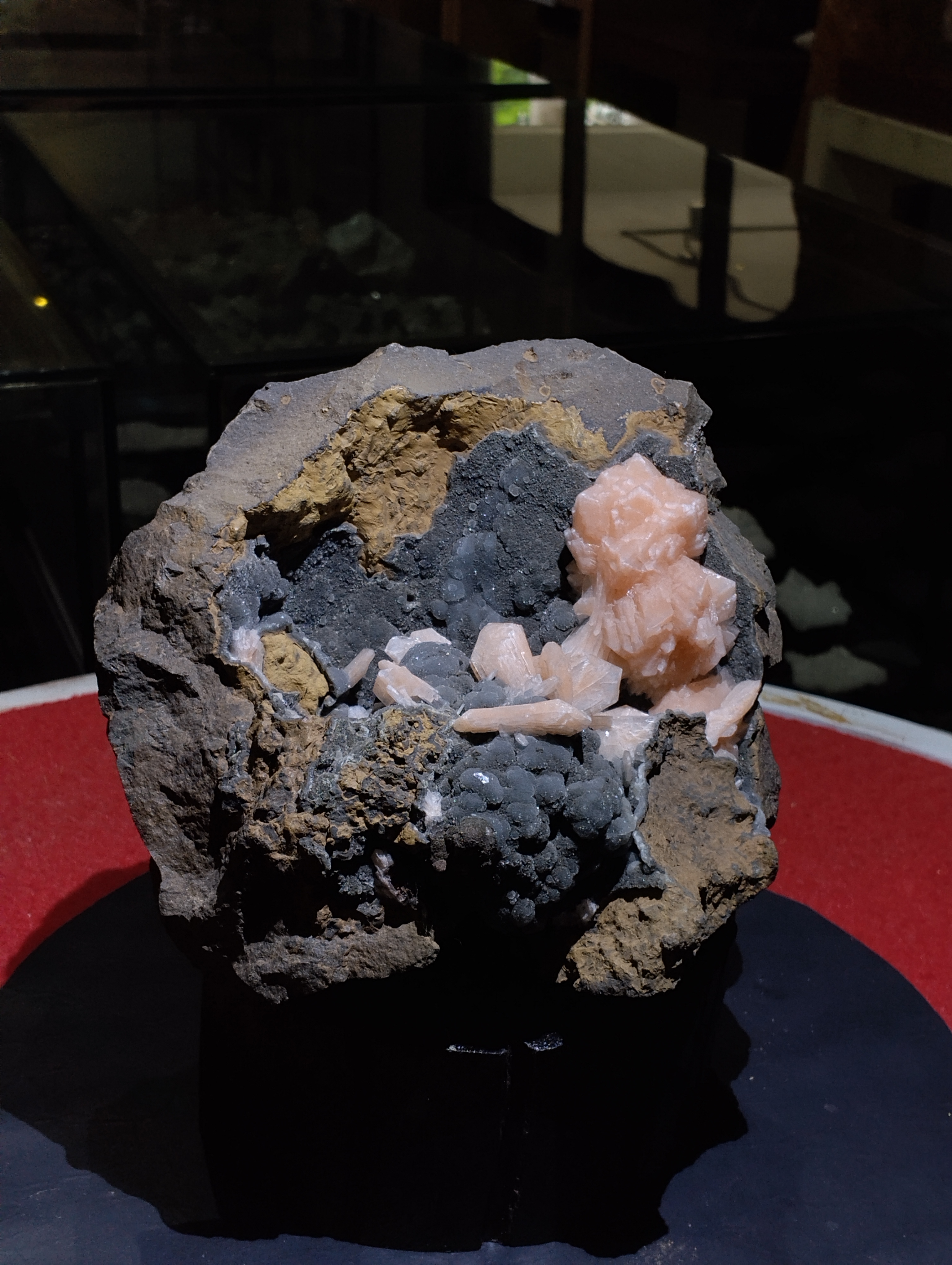 Natural Stilbite with Chalcedony on Basalt Matrix
✨ A striking mineral masterpiece, this specimen beautifully showcases the gentle elegance of peach Stilbite crystals resting against a dark Chalcedony druzy background, all set within a rugged Basalt matrix. This unique combination makes it not only a collector’s delight but also a powerful energy piece for spiritual and decorative purposes.
Appearance &amp; Structure
The stone presents a rough natural basalt base, providing a strong earthy foundation.
Clusters of soft, peach-colored Stilbite crystals bloom gracefully on the surface, their elongated, blade-like formations resembling delicate flower petals.
The background is coated with dark-grey Chalcedony druzy spheres, adding a beautiful textural and color contrast.
Together, the Stilbite and Chalcedony create a dramatic visual balance of light and dark, soft and solid, smooth and sparkling.